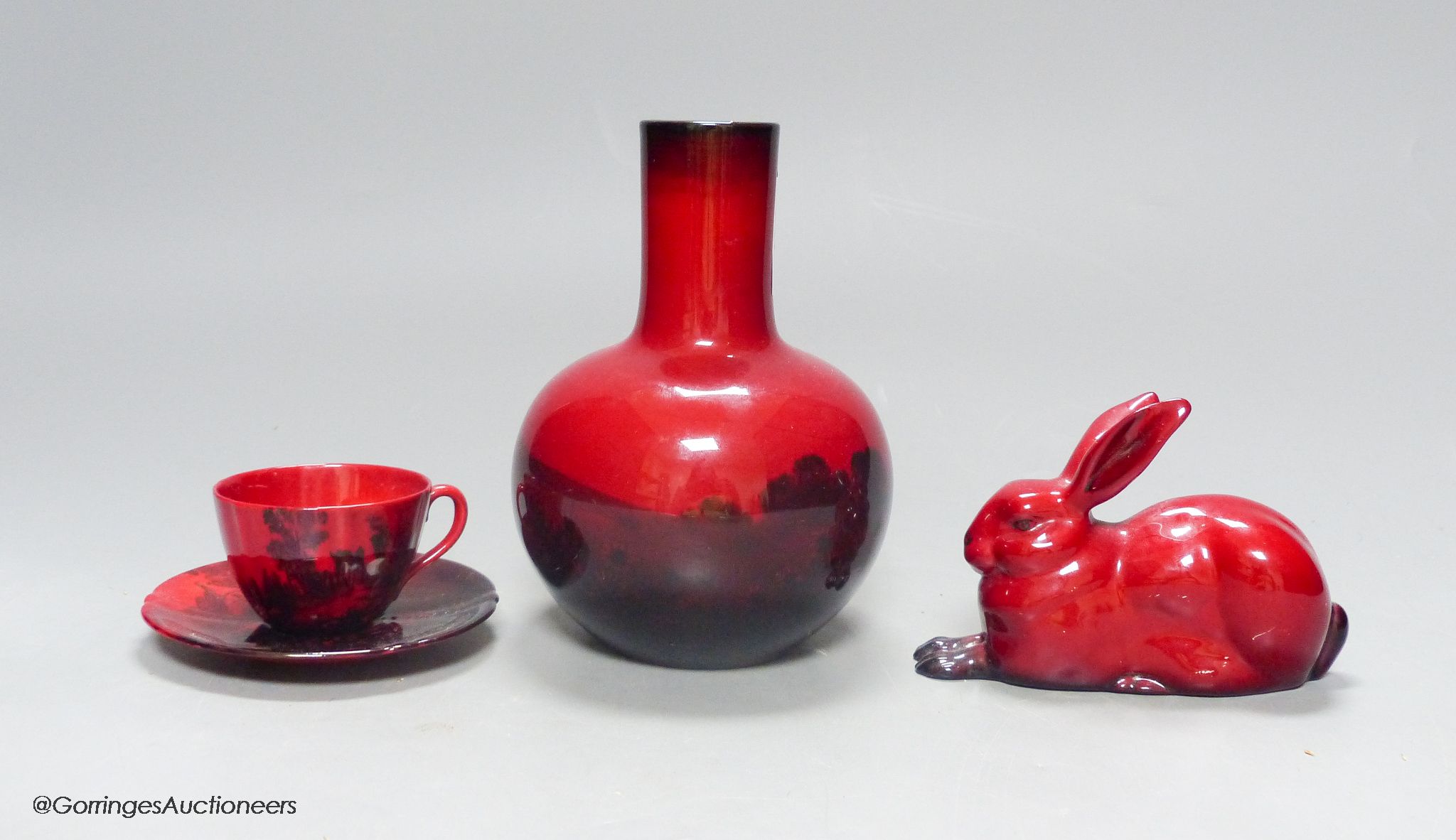 Royal Doulton flambe ware, consisting: a vase, a cup and saucer and a model of a hare (4)